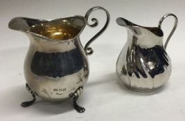 A silver cream jug with gilt interior. By JD&S. Approx. 32 grams.
