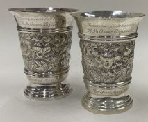 A pair of chased Jubilee silver beakers. Birmingham 1976. By DS Ltd.