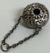 A novelty silver chased babies rattle with suspended chain. Birmingham 1900.