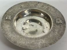 A silver armada dish with decorative bark finish to commemorate the Silver Jubilee.