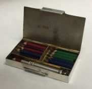 An attractive hinged top silver box mounted with miniature pencils. Birmingham.
