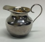 A small tapering silver cream jug together with one other. Approx. 50 grams.