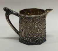 An attractive silver cream jug with floral decoration. Birmingham.