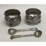 A good pair of chased silver salts on four feet together with spoons.