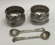 A good pair of chased silver salts on four feet together with spoons.