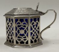 A Victorian silver and glass crested pierced mustard pot. London 1845.