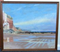 A framed painting depicting a view of Jacob's Ladder, Sidmouth at low tide.