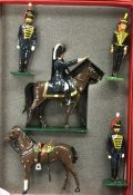 A group of painted lead soldiers on horseback.