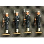 A set of four painted lead figures of soldiers in dress.