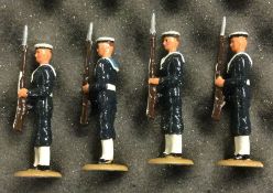 A set of four painted lead figures of soldiers in dress.