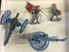 Two lead powder guns together with figures.