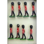 BRITAINS: A set of eight figures in dress outfits.