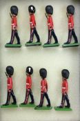 BRITAINS: A set of eight figures in dress outfits.