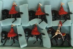 Six painted guards on horseback.