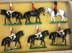 BRITAINS: Six painted figures on horseback.