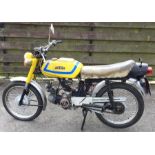 KTM: An old motorbike in yellow. Registration: NFB 715R.