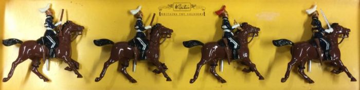BRITAINS: A set of four Dragoon Guards in box.