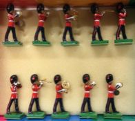 A set of painted lead figures in the form of a band.