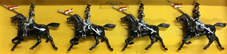BRITAINS: A boxed set of four figures on horse back.