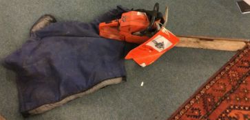 A Husqvarna chain saw together with a jacket.