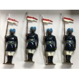 A set of four painted lead figures of soldiers in dress.