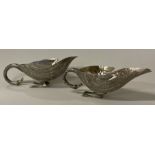 A novelty pair of silver sauceboats in the form of ducks.