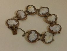 An unusual 9 carat eight pannel cameo bracelet with concealed clasp.