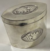 A chased silver hinged tea caddy embossed with shells. Sheffield 1902. By Thomas Bradbury & Sons.