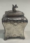 A George III chased silver tea caddy cast with squirrel finial. London 1765. By Pierre Gillois.