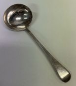 A George III silver sauce ladle with feather edge. London 1833.
