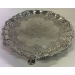 A fine George II fine bright-cut silver salver on three feet. London 1861. By Richard Rugg.