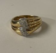 An 18 carat gold and diamond mounted cocktail ring.