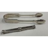 A pair of fiddle pattern silver sugar tongs together with an extending fountain pen.