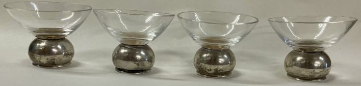 A set of four Norwegian silver and glass whisky cups.