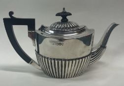 A fluted Victorian silver bachelor teapot. London 1895.