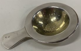 A Continental silver tea strainer on stand. Marked to base.