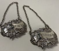 A fine pair of George III silver cast wine labels for 'Madeira' and 'Sherry'.
