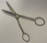 A large pair of George III silver scissors. Marked to handles.