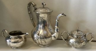 A Chinese silver chased coffee set. Marked underneath. c1900.