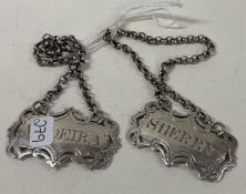 A pair of Victorian pierced silver wine labels for 'Madeira' and 'Sherry'.