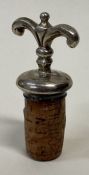 A Continental silver and wood bottle stopper.