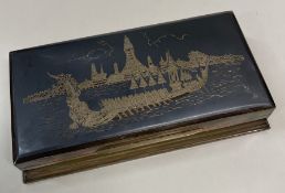 A large Thai silver and niello cigar box engraved with a boat scene.