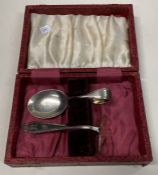 A cased silver pusher and spoon.