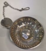 A 19th Century French silver wine taster and chain. Marked on handle.