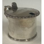 A George III silver and glass hinged mustard pot. London 1826.