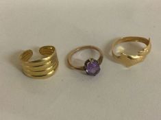 A 9 carat dolphin shaped ring together with an amethyst ring together with a reeded gold band.