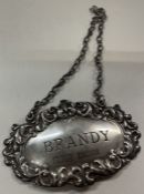 A silver wine label for 'Brandy' with shell border. Birmingham.