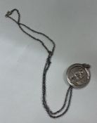 A silver necklace depicting Moses and the Staff of God.