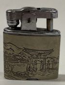 A Japanese Sterling silver engraved lighter. Marked sterling.