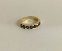 A heavy 18 carat gold sapphire half eternity ring.